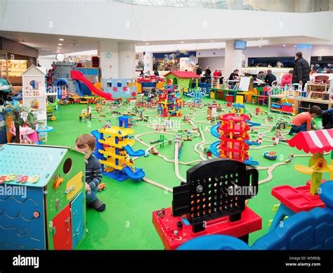 Kids playing in game zone in shopping mall. Play zone in modern ...