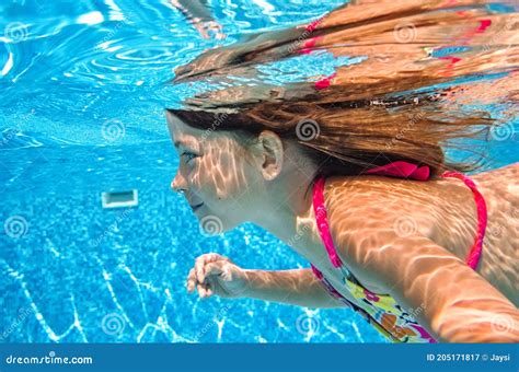 Little Child Swims Underwater in Swimming Pool, Happy Active Baby Girl Dives and Has Fun Under ...