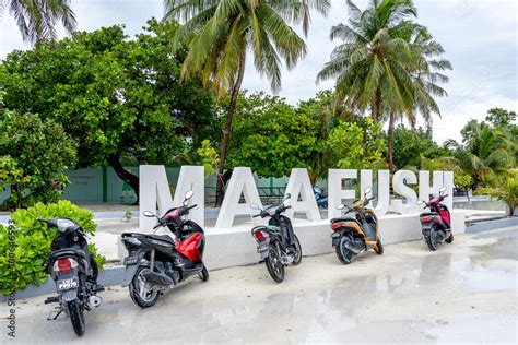 Maafushi, Maldives - November 29, 2018: Maafushi sign with motorcycles ...