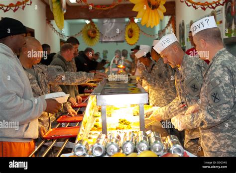 Unit commanders, officers, and first sergeants serve a Thanksgiving meal to Soldiers and ...