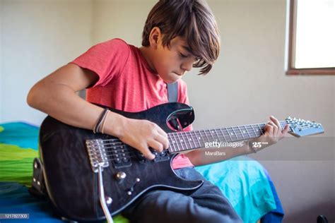 Latinx pre-adolescent child learning to play electric guitar at home | Kids learning, Children ...