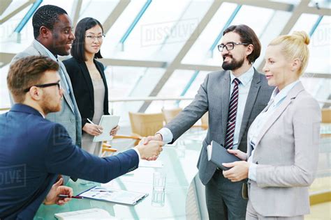 Businessmen shaking hands after successful meeting - Stock Photo - Dissolve