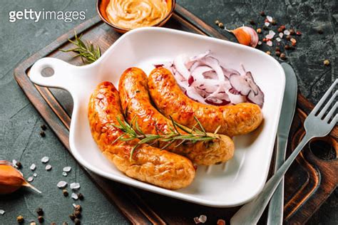 Fried sausages with mustard and onions close up 이미지 (1278813027) - 게티이미지뱅크