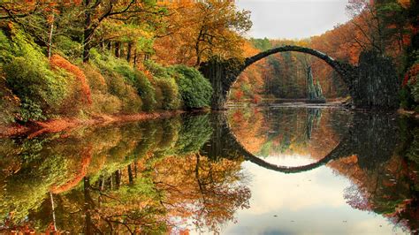 Devil's Bridge In Middle Of River In Forest With Reflection Surrounded By Blossom Trees Nature ...