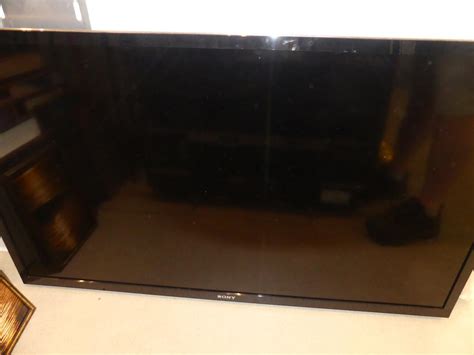 Murrays Auctioneers - Lot 452: Sony TV with wall mount