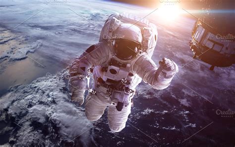 Astronaut in outer space against the backdrop of the planet earth ...