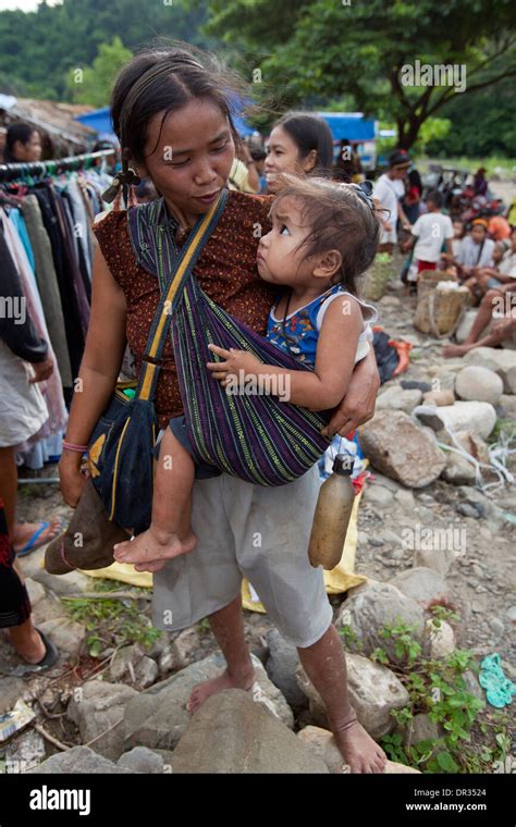 A Hanunoo Mangyan woman and her child shops at a Mangyan market near Mansalay, Oriental Mindoro ...