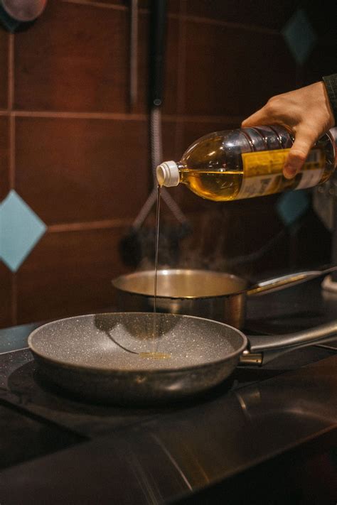 Person Pouring cooking Oil in a Pan · Free Stock Photo