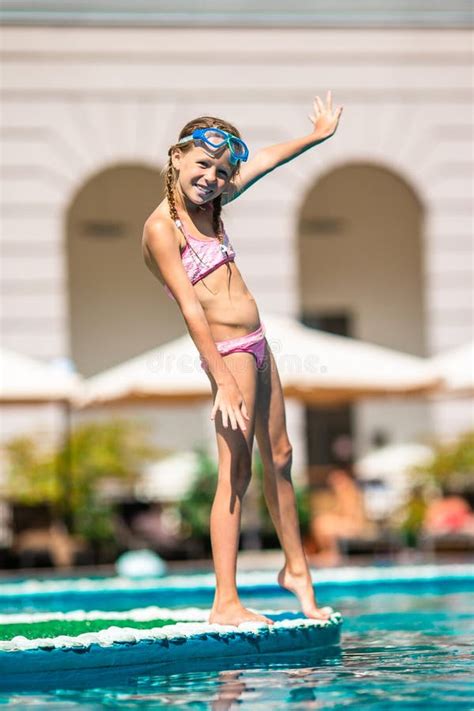 Adorable Little Girl Swimming at Outdoor Swimming Pool Stock Photo ...