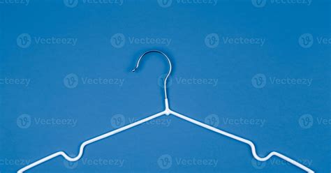 White clothes hanger on blue background 2437490 Stock Photo at Vecteezy