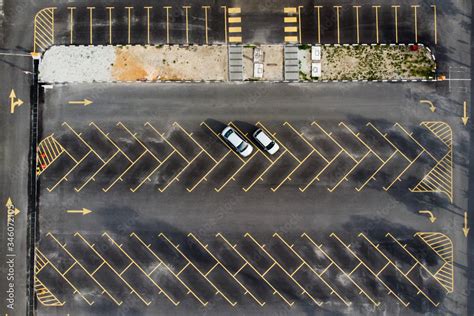 Aerial top down view of the open space car parking lots with only two silver cars Stock Photo ...