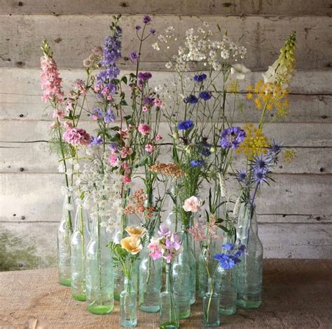 Pretty found wildflower display in vintage antique bottles | Spring wedding centerpieces, Wild ...