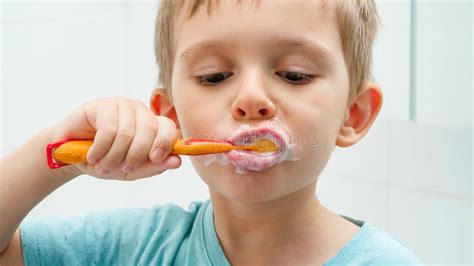 Funny child brushing teeth stock image. Image of young - 26631843