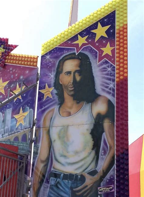 A large painting of Nicolas Cage on a carnival ride. : r/onetruegod