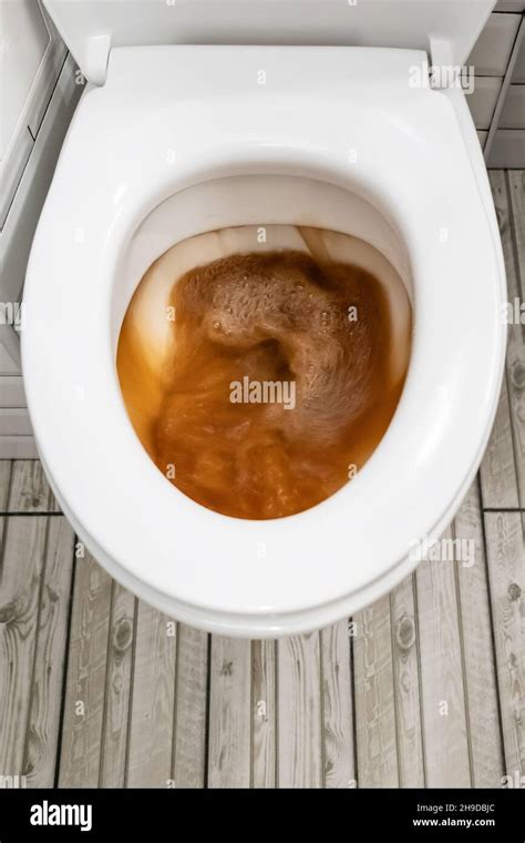 Toilet bowl that flushes out rusty, dirty water. Close-up. Top view Stock Photo - Alamy