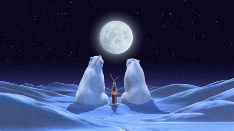 Coca Cola glass bottle between two white polar bears sitting on snow field under full moon ...