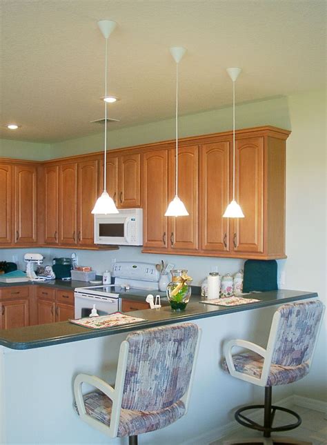 low hanging mini pendant lights over kitchen island for an apartment