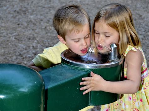 Kid Drinking Water From Fountain