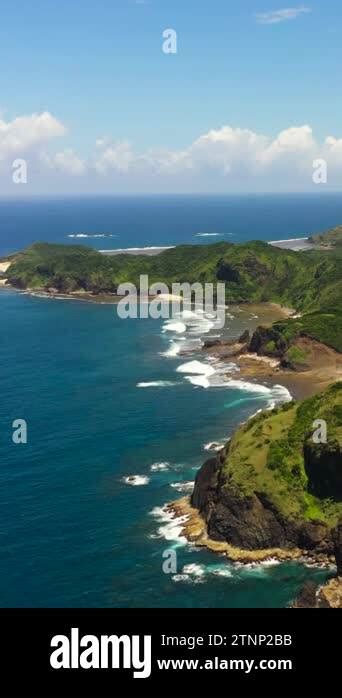 The coast of the island with beaches and rainforest. Cape Engano ...