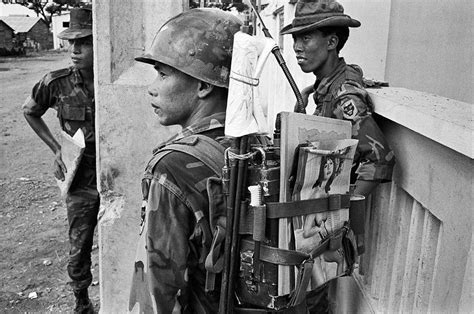 ARVN Rangers in Saigon during the Tet Offensive, 1968. The radio operator has a pin-up strapped ...