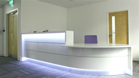 Office reception desk with sensored LED lighting at Crowe Clark Whitehill #officefitout #officed ...