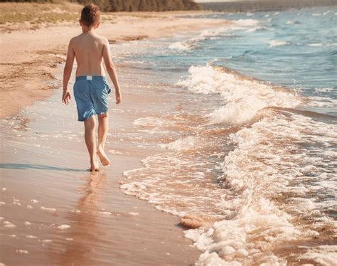 Boy Barefoot is Jumping on the Beach in Water Stock Image - Image of outside, lifestyle: 193936081