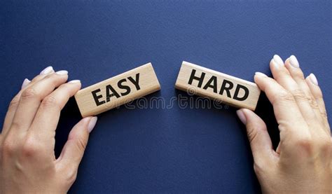 Easy or Hard Symbol. Concept Word Easy or Wooden Blocks. Businessman Hand. Beautiful Deep Blue ...