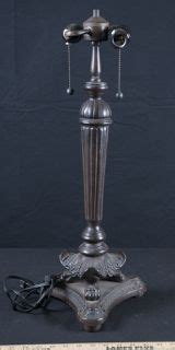 METAL TIFFANY STYLE LAMP BASE WITH A FLUTED STEM AND CLAW FEET. TWO BULBS FIT WITH CHAIN PULLS ...