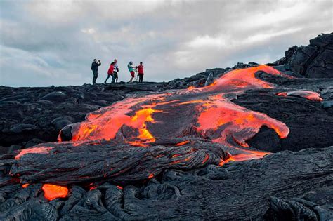 Daring tourists hike on ACTIVE volcano in Hawaii to get as close as possible to the lava flows ...