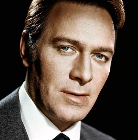 a close up of a person wearing a suit and tie with one eye open, looking at the camera