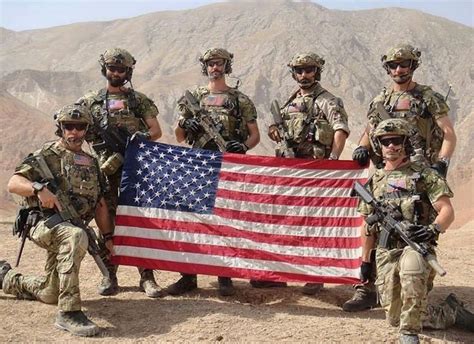 the soldiers are posing with an american flag