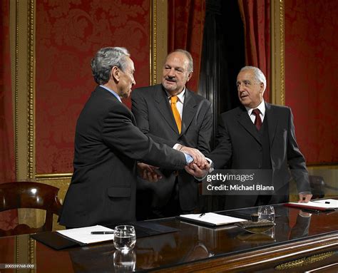 Three Politicians Shaking Hands At Conference Table Smiling High-Res Stock Photo - Getty Images