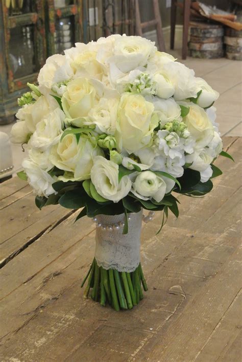 Bridal bouquet with roses, ranunculus, lisianthus, stocks and hydrangea. Designed by Forget-Me ...