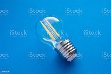 Led lamp on the blue background. Selective focus. - Stock Image - Everypixel