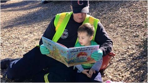 Photo of First Responder Reading to Little Boy Goes Viral