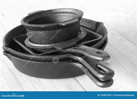 Set of Black Cast Iron Pots and Pans on Grey Wood Stock Image - Image ...