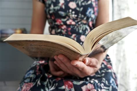 Person in Black and White Floral Dress Reading Book · Free Stock Photo