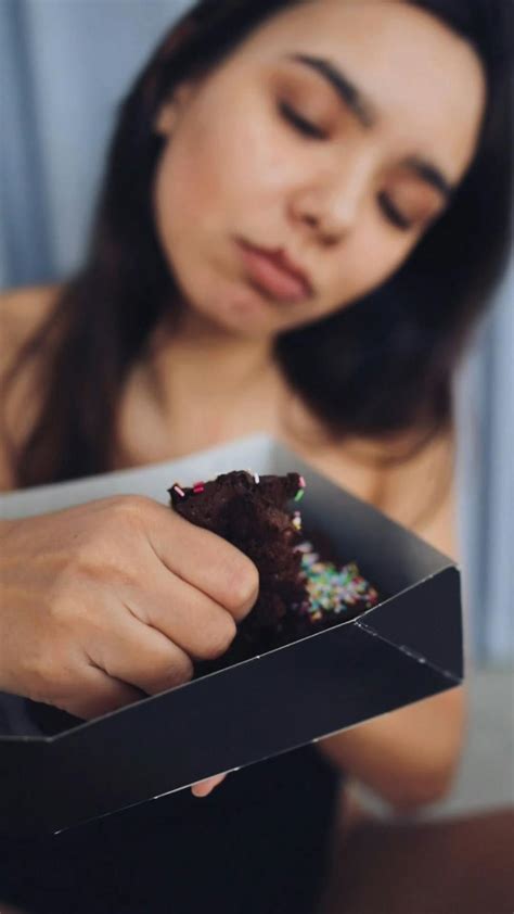 Woman Sitting on Bean Bag Chairs Eating Donut · Free Stock Video