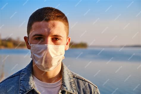 Premium Photo | Young boy wearing protective surgical face mask to prevent coronavirus on the ...