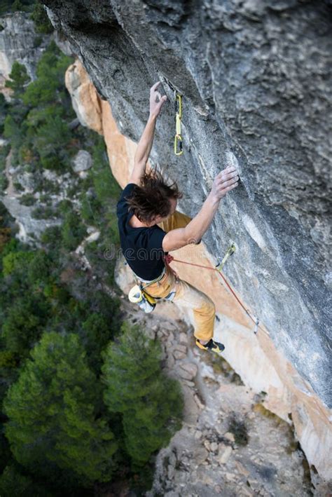 Outdoor Sport Activity. Rock Climber Ascending a Challenging Cliff. Extreme Sport Climbing Stock ...