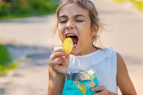 Premium Photo | The child is eating chips. selective focus. kid.