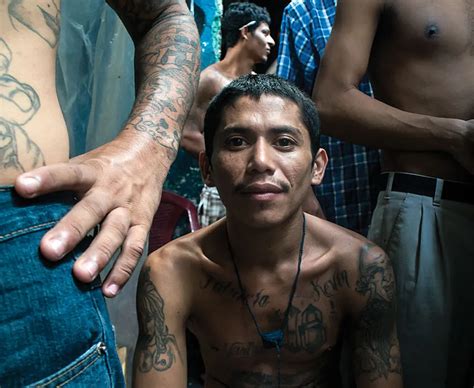 A young member of the Barrio 18 gang sits inside a cramped prison in El ...