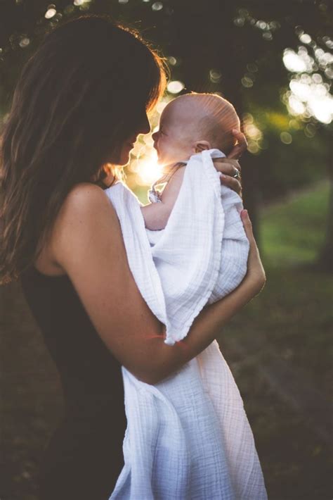 mom holding baby with sun happy - Inspire