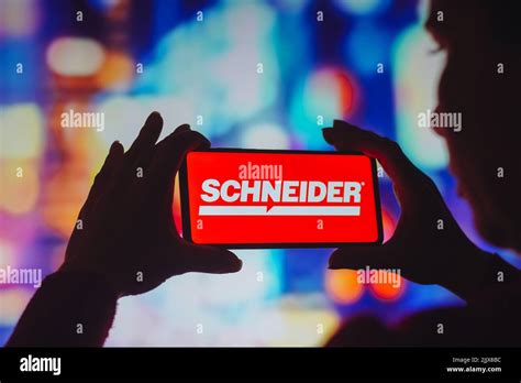 In this photo illustration, the Schneider National logo is displayed on a smartphone screen ...