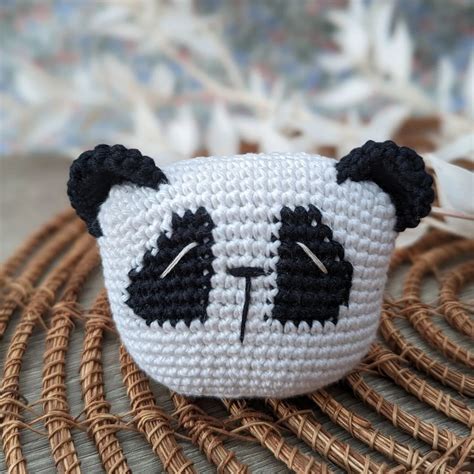 Crochet pattern with panda head, black eyes.