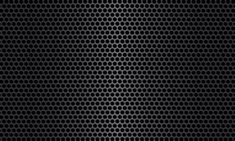 Black metal texture steel background. The pattern metal sheet is perforated with a flash of ...