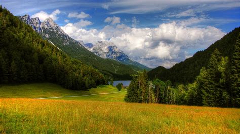 Green Trees Slope Mountains Grass Field Forest Landscape View Of River Under White Clouds Blue ...