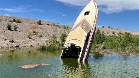 Once sunken boat now partially underwater again at Lake Mead after water increase