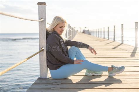 Young Woman on a Pontoon in Front of the Sea on a Sunny Day Stock Photo ...