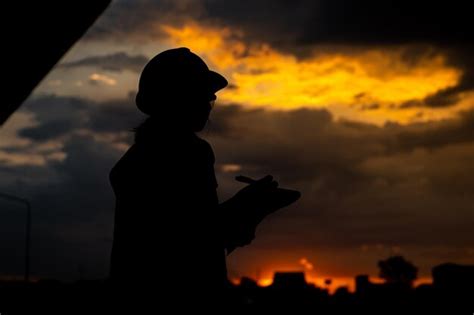 Premium Photo | Silhouette of young asian female engineer on sunset